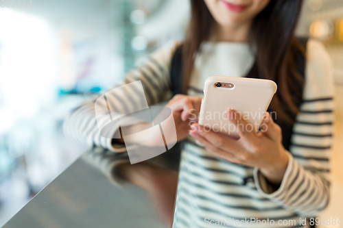 Image of Woman checking something on mobile phone