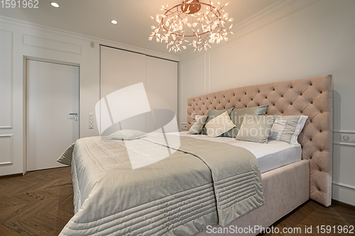 Image of Big comfortable double bed in elegant classic bedroom