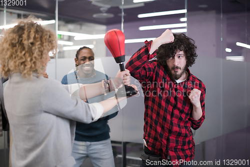 Image of multiethnics business team boxing at office