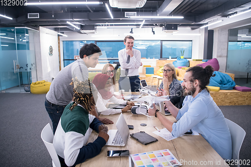 Image of multiethnic business team learning about drone technology