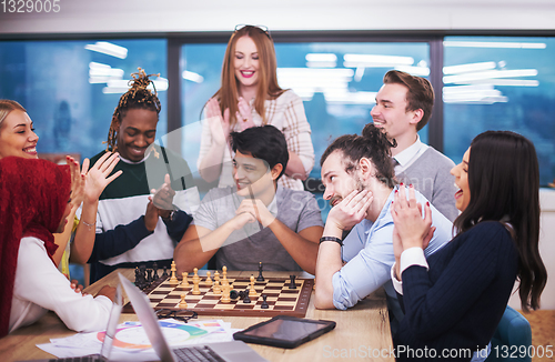 Image of multiethnic group of business people playing chess