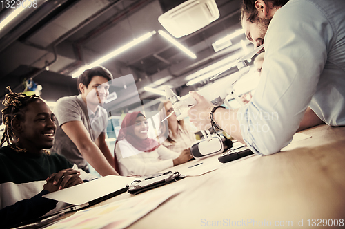 Image of multiethnic business team learning about drone technology