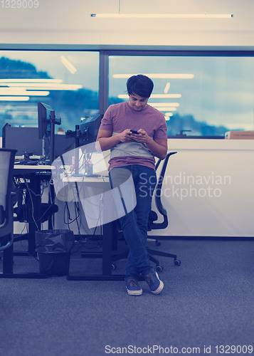Image of software developer using mobile phone