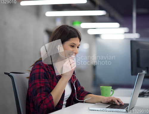 Image of female software developer using laptop computer