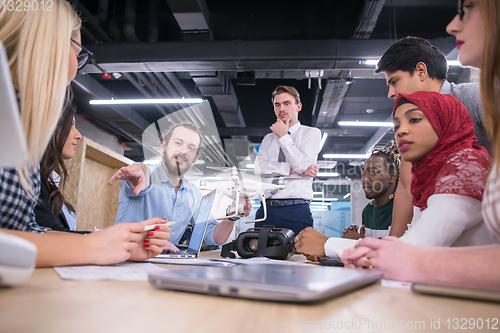 Image of multiethnic business team learning about drone technology