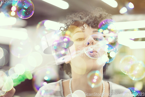 Image of software developer having fun while making soap bubble