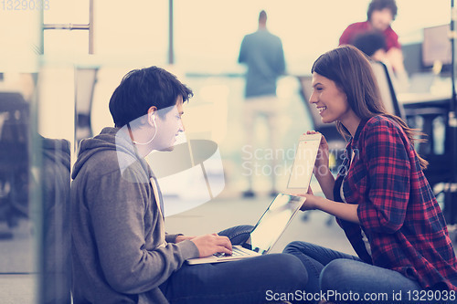 Image of software developers couple working on the floor