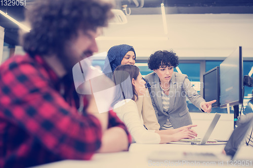 Image of young multiethnics team of software developers working together