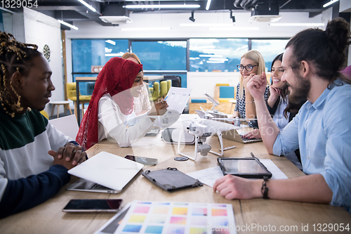 Image of multiethnic business team learning about drone technology