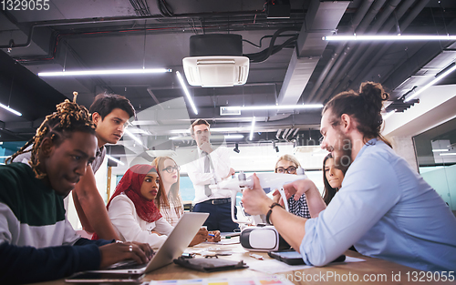 Image of multiethnic business team learning about drone technology