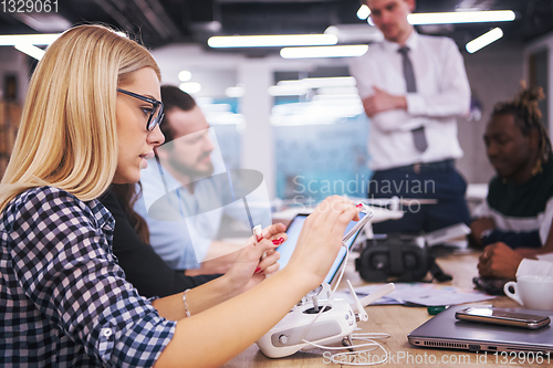 Image of blonde business woman learning about drone technology