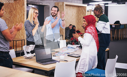 Image of multiethnic Group of young business people celebrating success