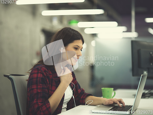 Image of female software developer using laptop computer