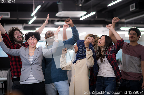 Image of portrait of young excited multiethnics business team