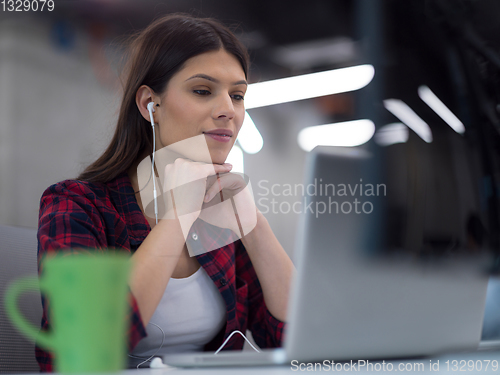 Image of female software developer using laptop computer