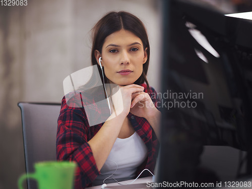 Image of female software developer using laptop computer