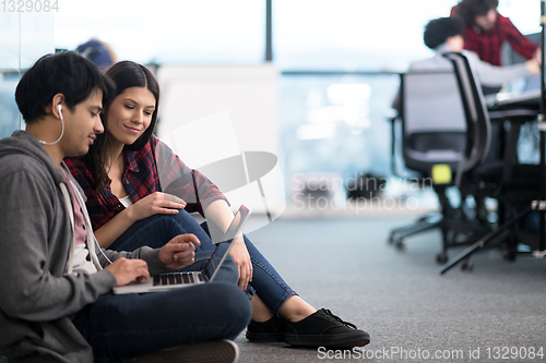 Image of software developers couple working on the floor