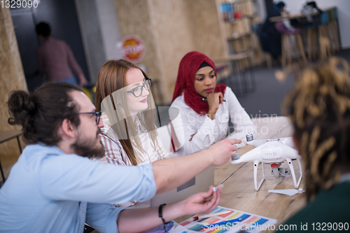 Image of multiethnic business team learning about drone technology