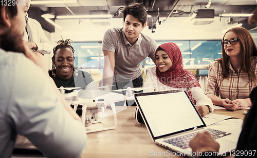 Image of multiethnic business team learning about drone technology