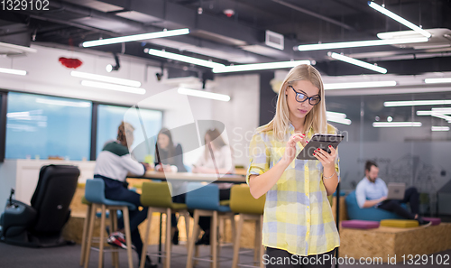 Image of blonde businesswoman working online using digital tablet