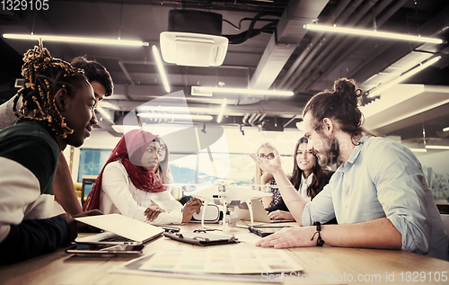 Image of multiethnic business team learning about drone technology