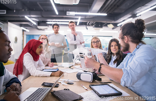 Image of multiethnic business team learning about drone technology