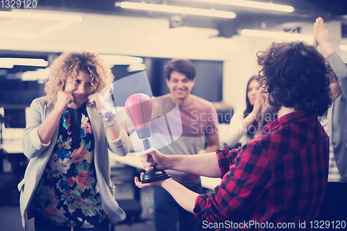 Image of multiethnics business team boxing at office