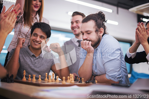 Image of multiethnic group of business people playing chess