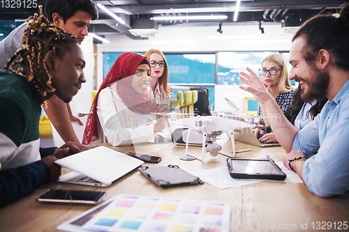 Image of multiethnic business team learning about drone technology