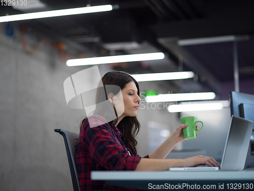 Image of female software developer using laptop computer