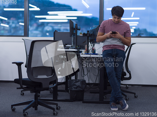 Image of software developer using mobile phone