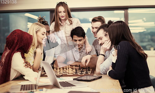 Image of multiethnic group of business people playing chess