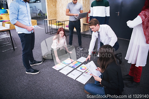 Image of redhead businesswoman having meeting with Multiethnic startup bu