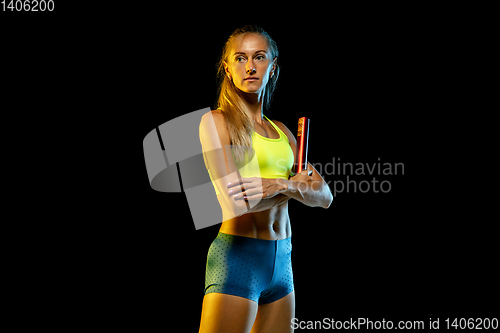 Image of Professional female relay racer training on black studio background in neon light