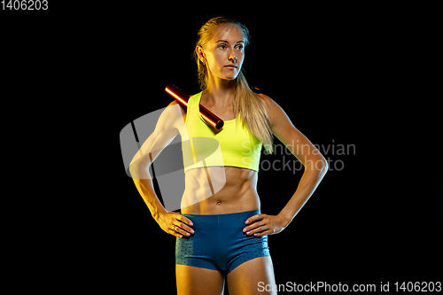 Image of Professional female relay racer training on black studio background in neon light