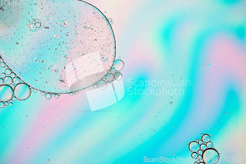 Image of Holographic colorful abstract background with oil drops on water