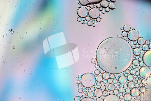 Image of Holographic colorful abstract background with oil drops on water