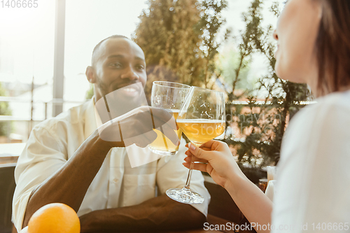 Image of Young group of friends drinking beer and celebrating together