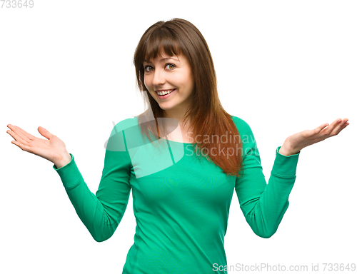Image of Portrait of a young woman raised her hands up