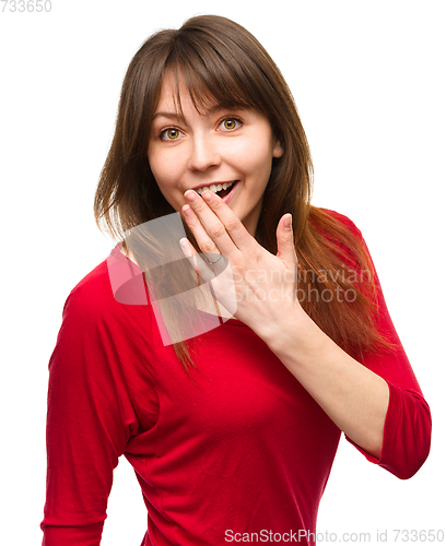 Image of Woman is covering her mouth in astonishment