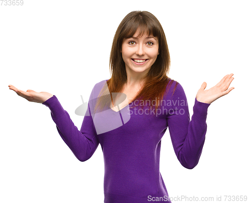 Image of Portrait of a young woman raised her hands up