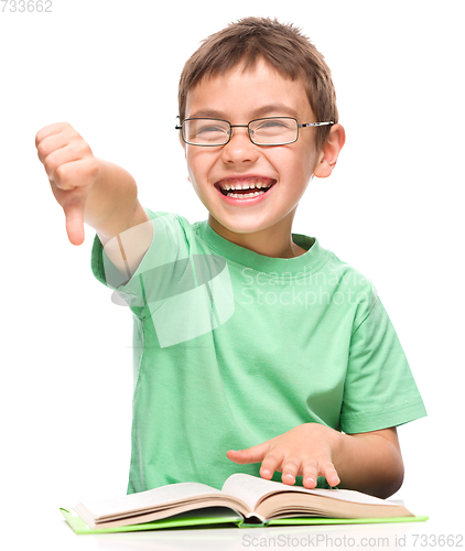 Image of Little boy is reading a book