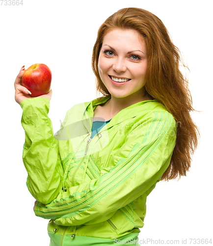Image of Young happy girl with apple