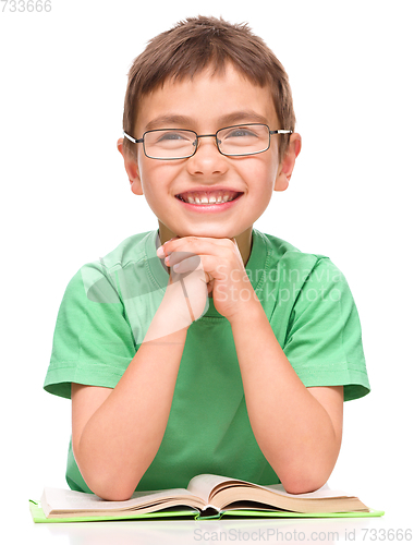 Image of Little boy is reading a book