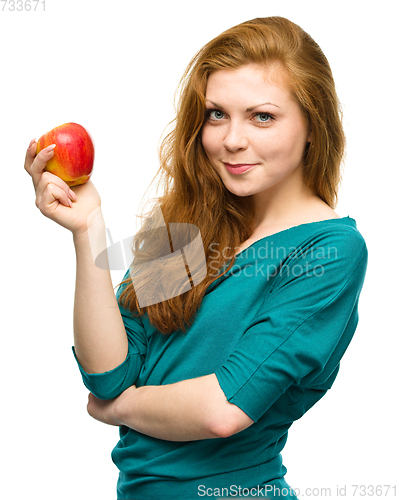 Image of Young happy girl with apple