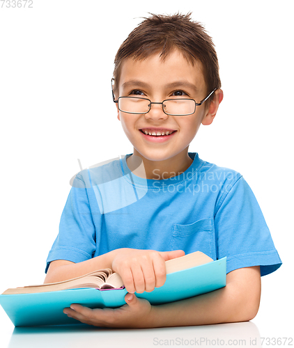 Image of Little boy is reading a book