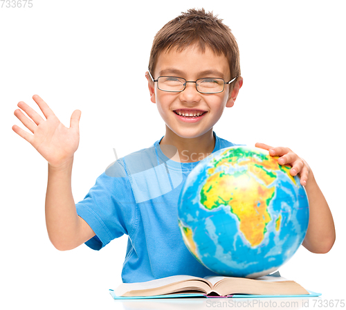 Image of Little boy is holding globe