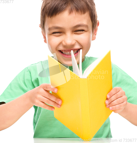 Image of Little boy is reading a book