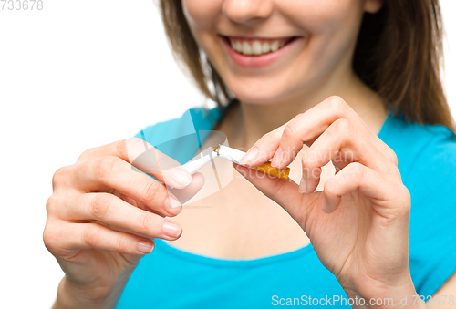 Image of Young woman is breaking a cigarette