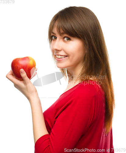 Image of Young happy girl with apple